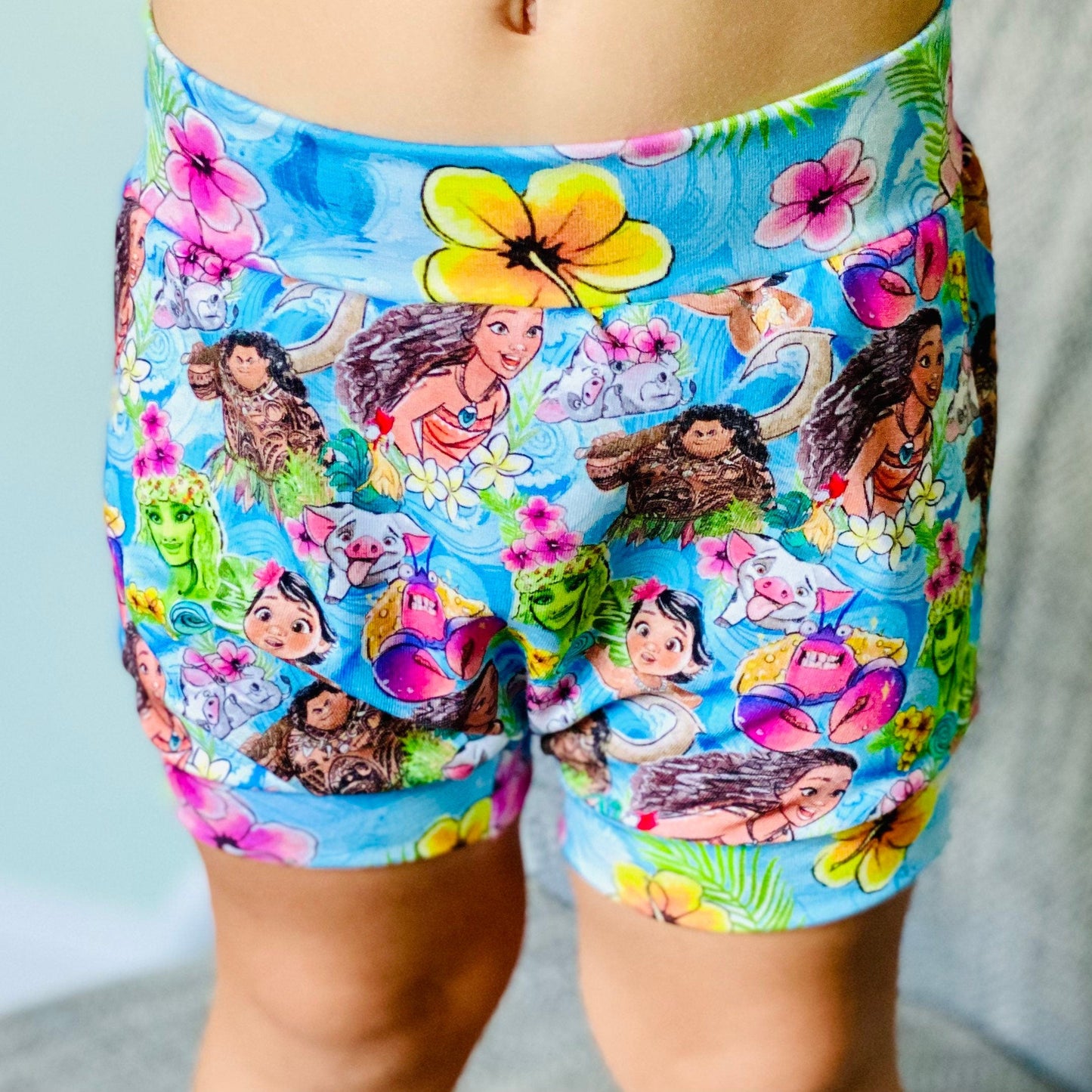 Child modeling a handmade kids summer lounge set with floral print, featuring matching t-shirt and shorts sewn from a beginner-friendly PDF sewing pattern – perfect for boys or girls. Aloha sewing company. Sewing with knit fabric. Serger.