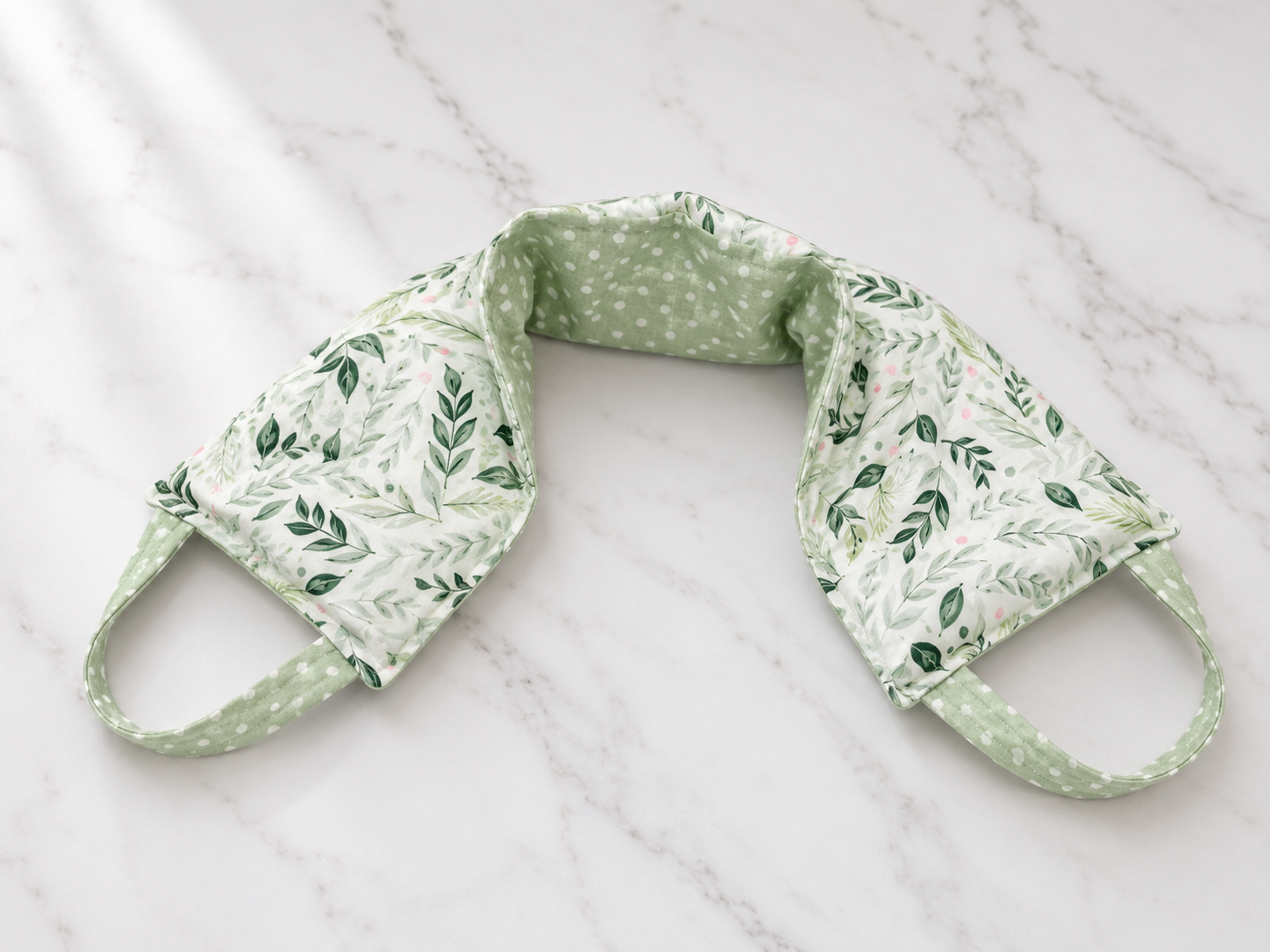Reusable neck and shoulder wrap designed for microwave heat therapy or freezer cold therapy, made using a printable PDF sewing pattern from Aloha Sewing Company.