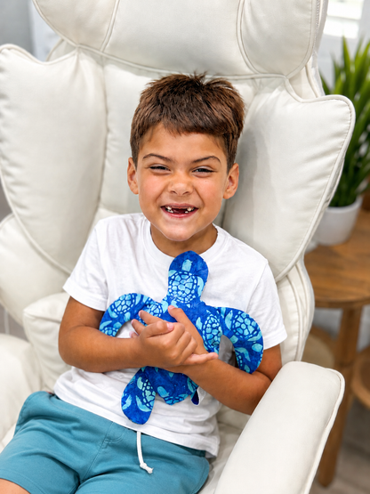 Child holding the small Baby Honu Sea Turtle Memory Plush sewn using the printable PDF sewing pattern. Easy beginner stuffed sea turtle sewing project by aloha sewing company.